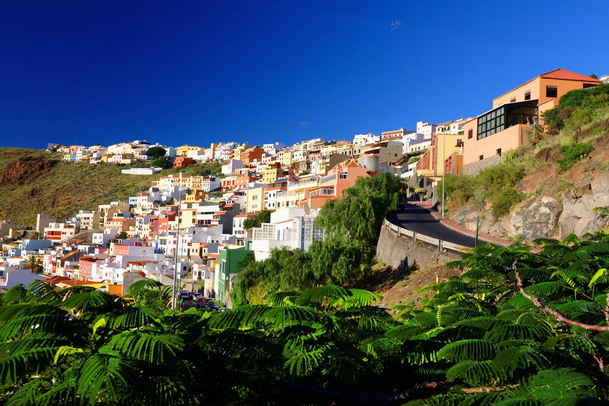 San Sebastian de la Gomera, Canary Islands, Spain. A deep blue sky above and lush dense foliage on the bottom.