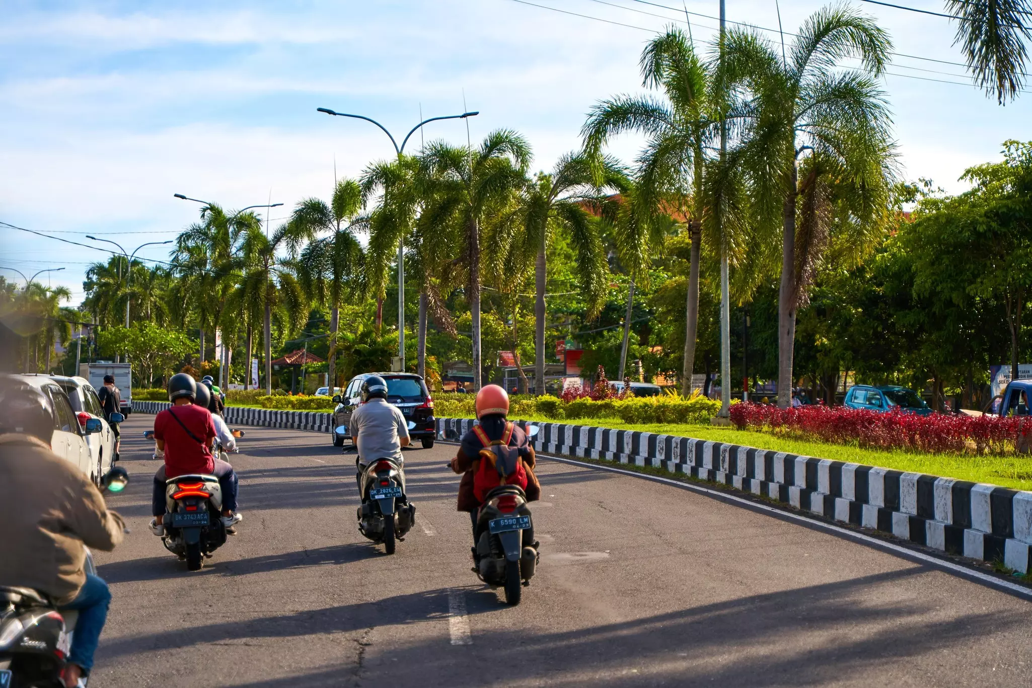 Cars and scooters on a main road in Bali. 