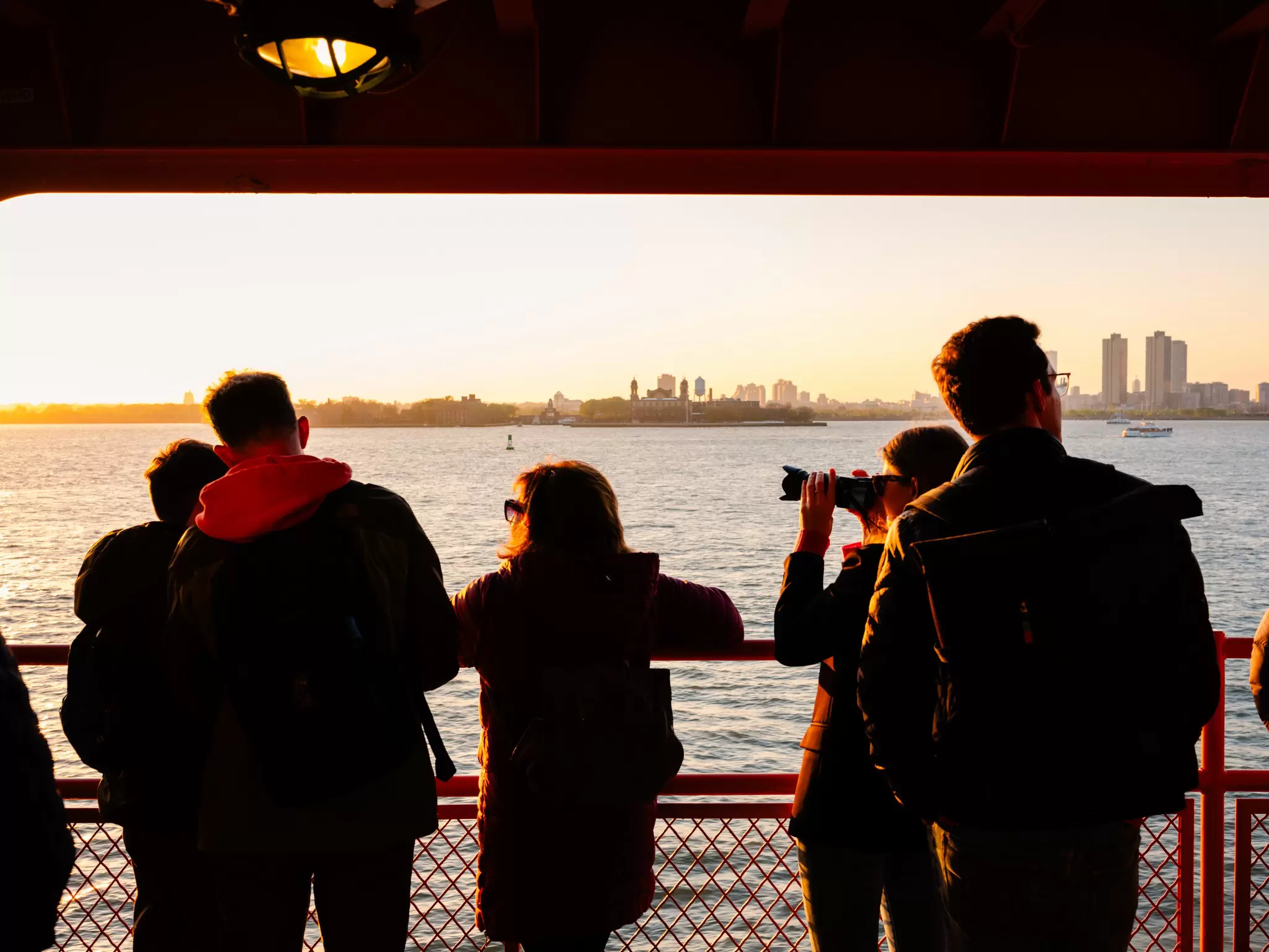 Anthony Nazario for Lonely Planet
The Staten Island Ferry from Staten Island, NY to Manhattan. Commuters and tourists enjoy the setting sun.