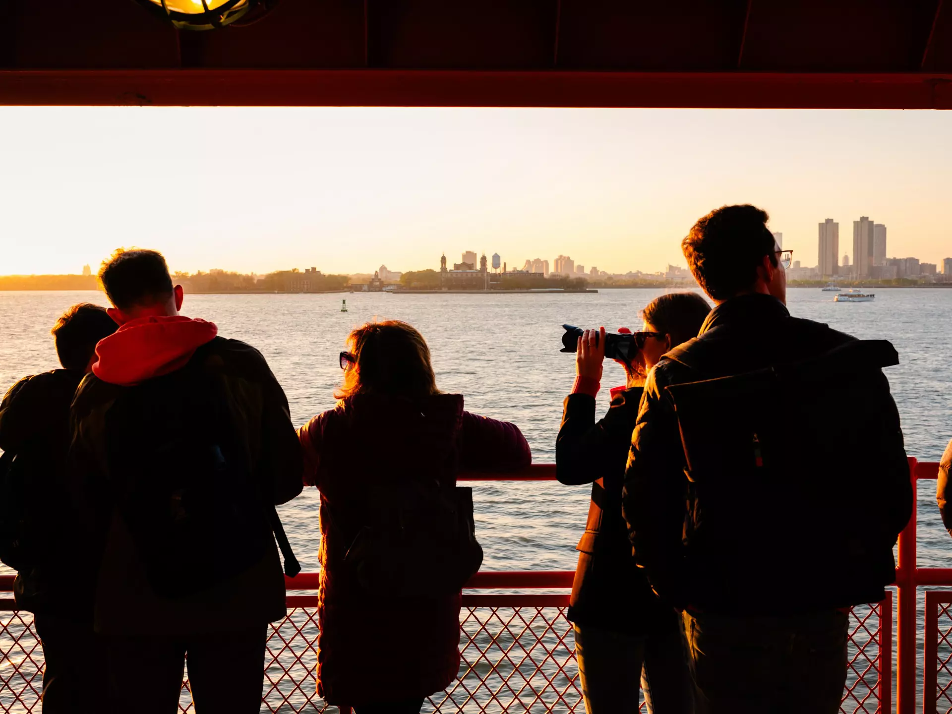 Anthony Nazario for Lonely Planet
The Staten Island Ferry from Staten Island, NY to Manhattan. Commuters and tourists enjoy the setting sun.