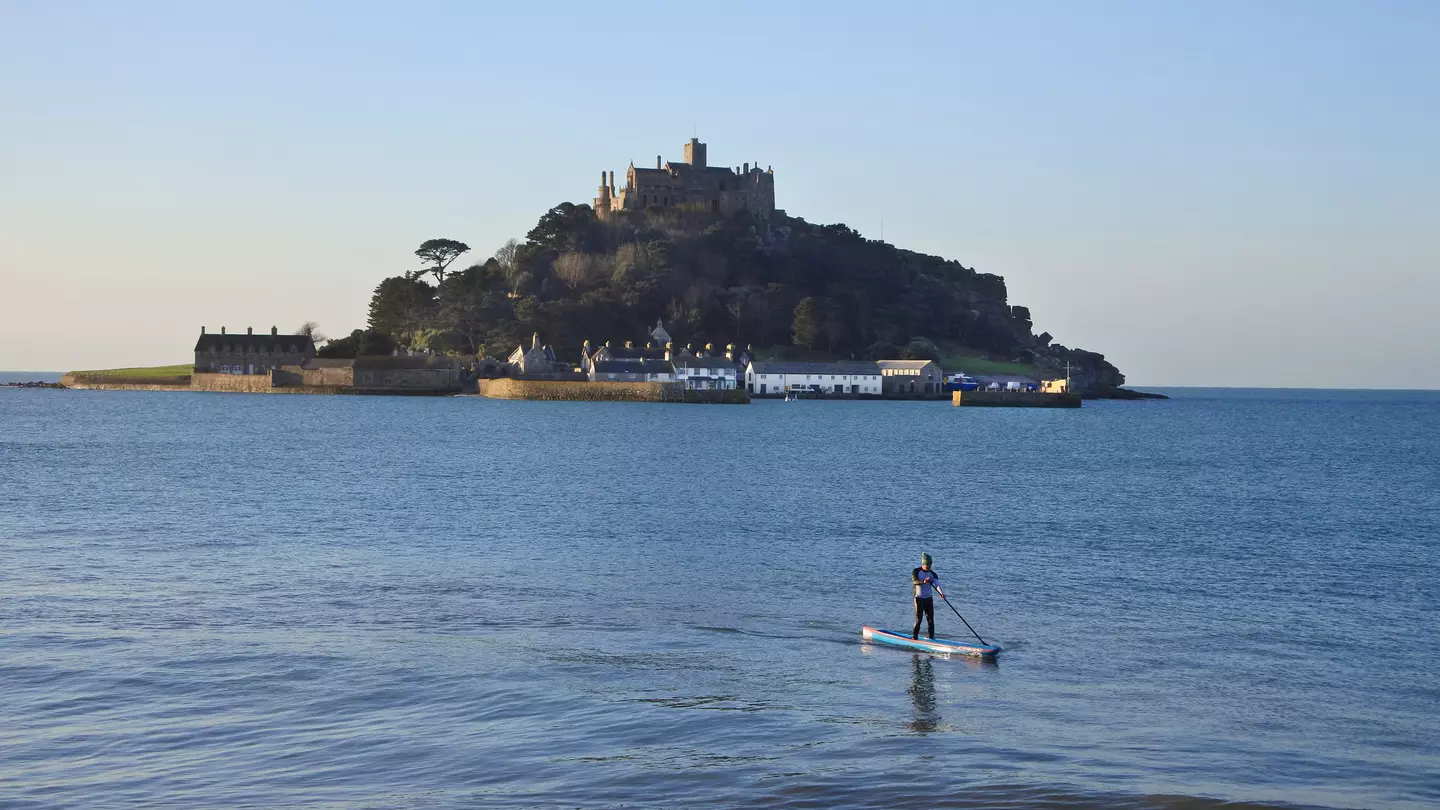 SUP paddleboarder in front of St. Michael's Mount, Cornwall