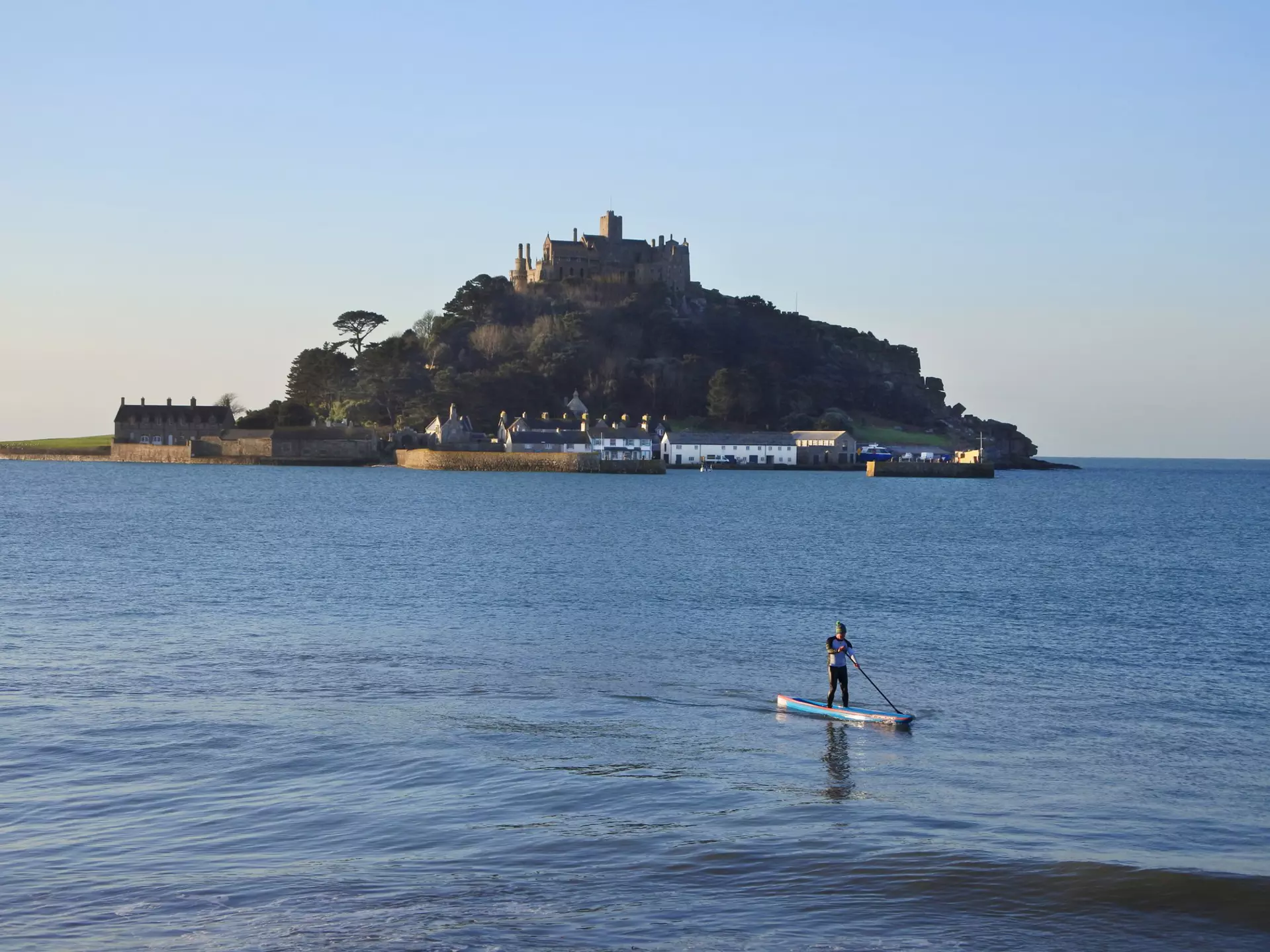 SUP paddleboarder in front of St. Michael's Mount, Cornwall