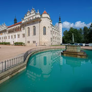 A fountain in the foreground reflects a view of the Santa Barbara Mission of California, a spanish-style church