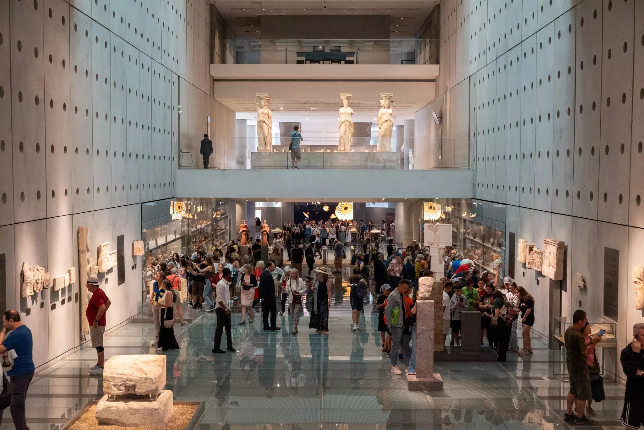 Athens, Greece - May 26 2024: Visitors in the main hall of Acropolis Museum in Athens