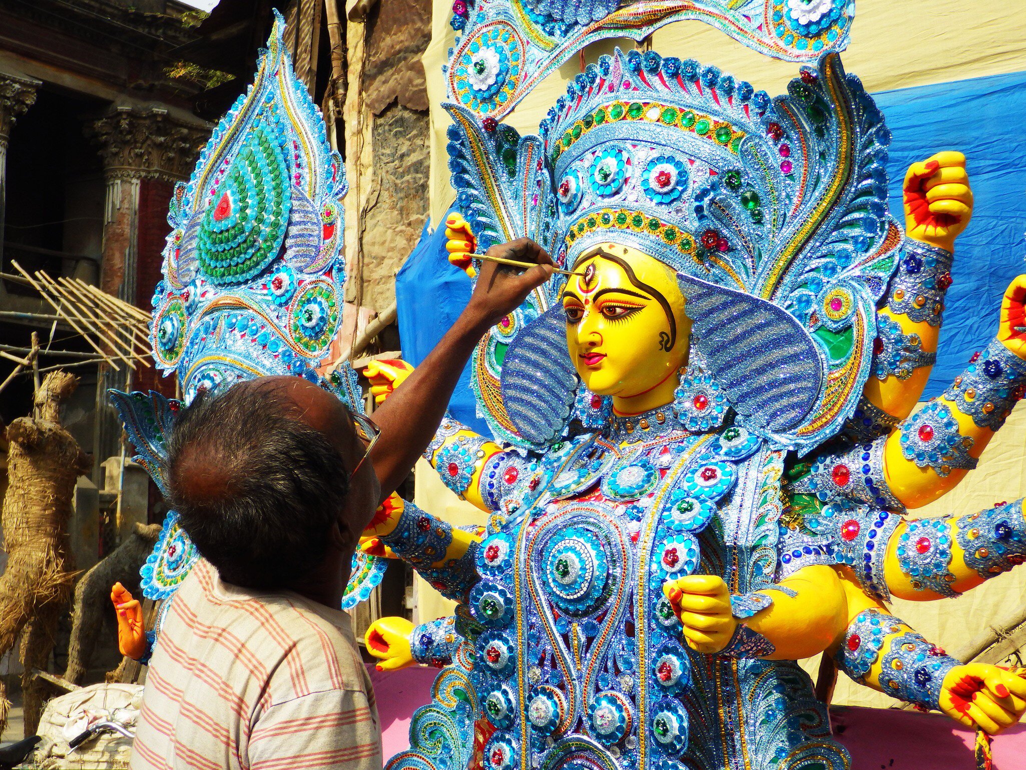 Indian craftsman painting God's statues at Kumartuli district of Kolkata, West Bengal, India.
