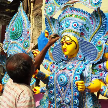 Indian craftsman painting God's statues at Kumartuli district of Kolkata, West Bengal, India.