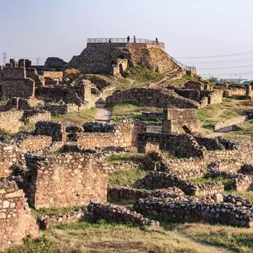 Tughlaqabad Fort in Delhi, a 14th-century medieval fortress built by Ghiyas-ud-din Tughlaq. Showcases massive stone walls, ancient ruins, and the architectural legacy of the Delhi Sultanate.