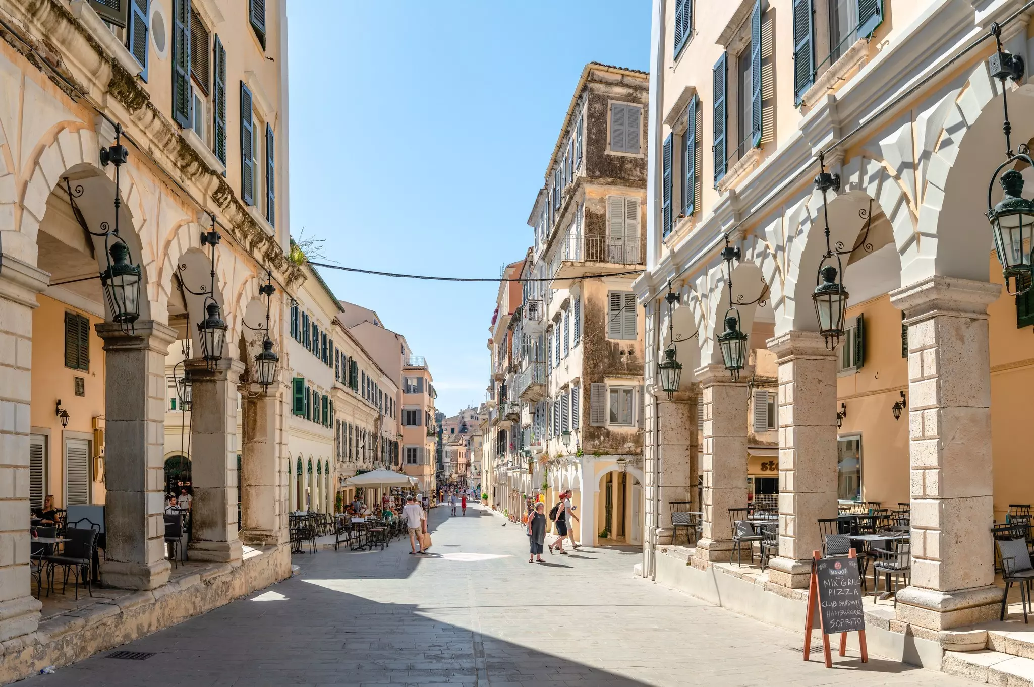 Corfu, Greece - June 3 2022: View of Nikiforou Theotoki St, a famous pedestrian retail street in the old town that runs to the Liston and Spiniada Square., License Type: media, Download Time: 2024-11-26T02:38:35.000Z, User: mvm_lonelyplanet, Editorial: true, purchase_order: 56530 - Guidebooks, job: Global Publishing-WIP, client: Greece 17, other: Virginia Moreno
