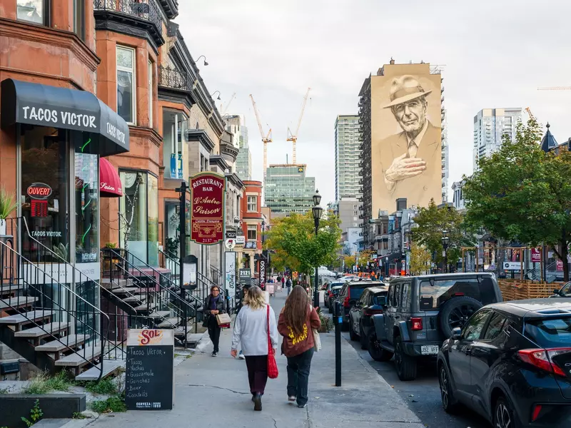 People walking on a city street in autumn.