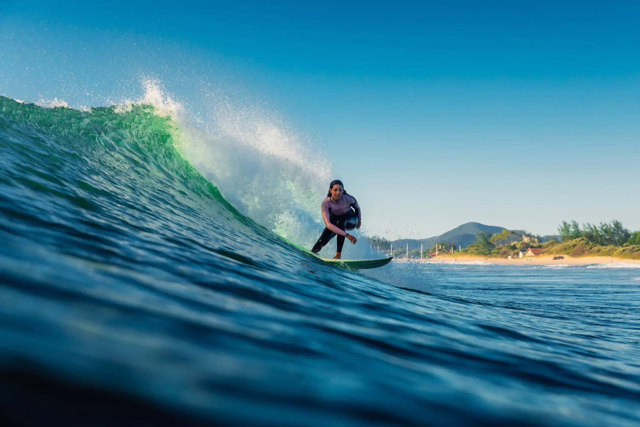 Woman during surfing with morning light. Surfer girl on surfboard. 