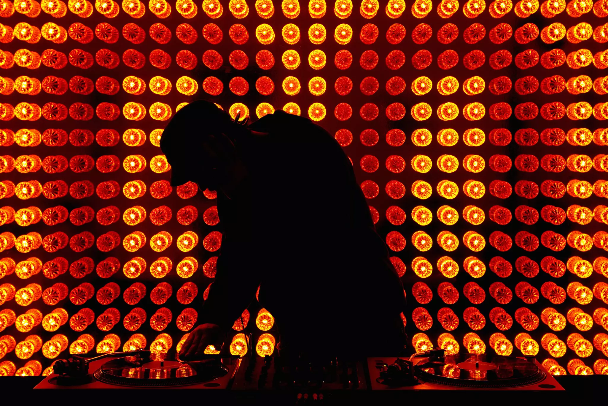 A DJ framed by stage lights in Berlin, Germany.