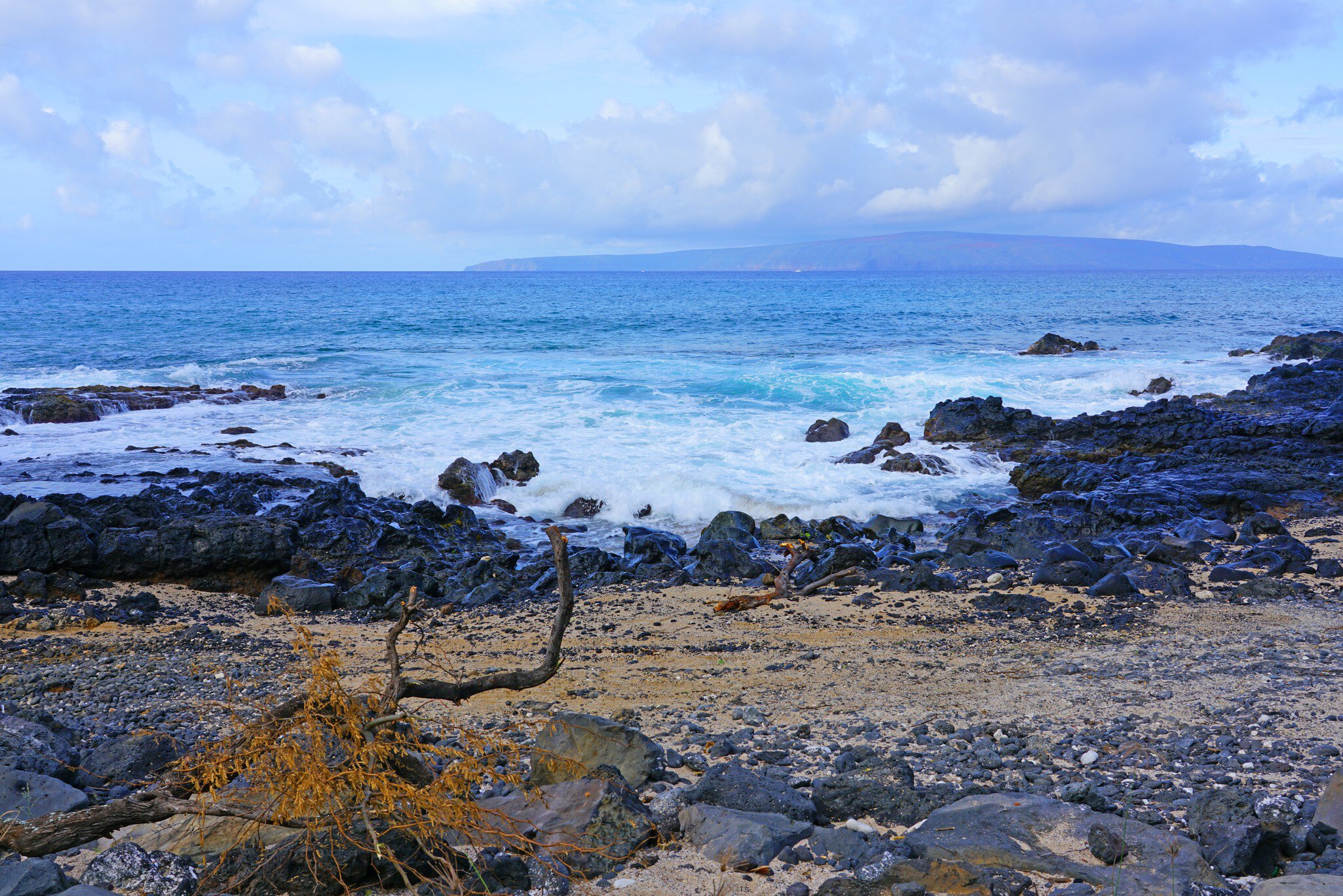 View of black lava rock and blue ocean at the Ahihi-Kinau Natural Area Reserve, on the West shore of Maui south of Wailea and Makena, Hawaii; Shutterstock ID 1166522590;
