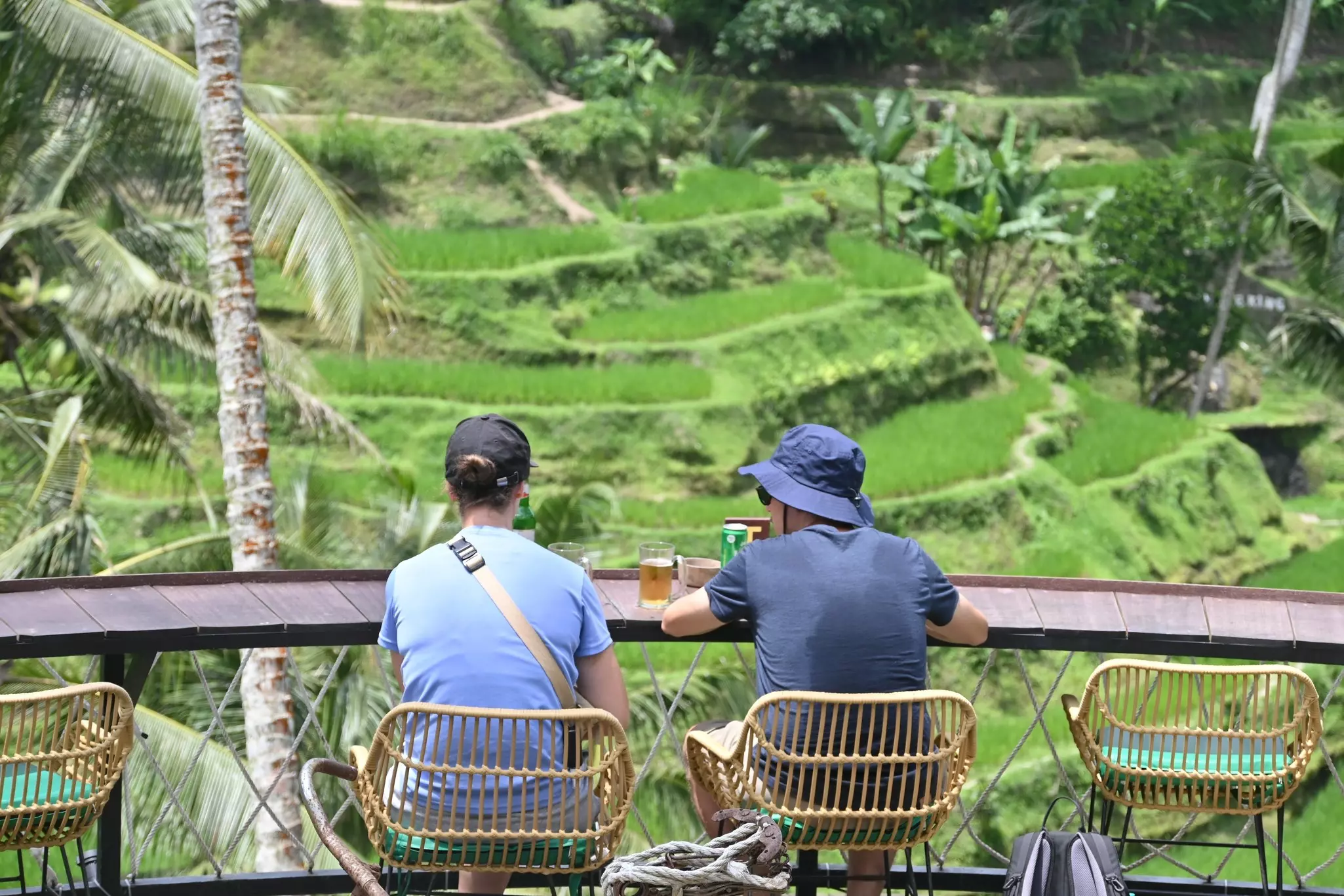 Two tourists in a cafe overlooking the Tegallalang rice terraces near Ubud in Bali, Indonesia.