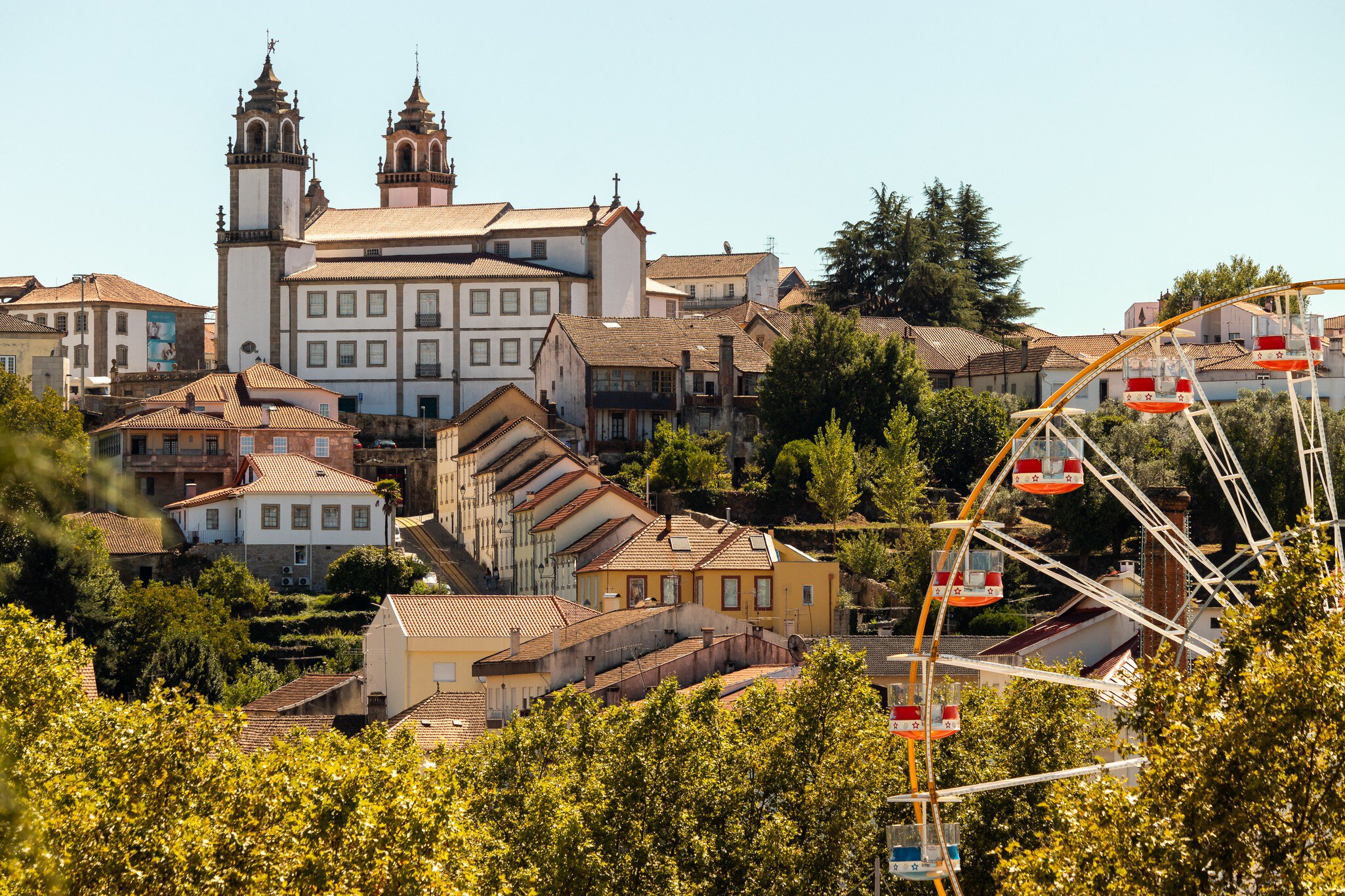 Viseu Cathedral in the background with the Ferris wheel at the São Mateus fair in the foreground