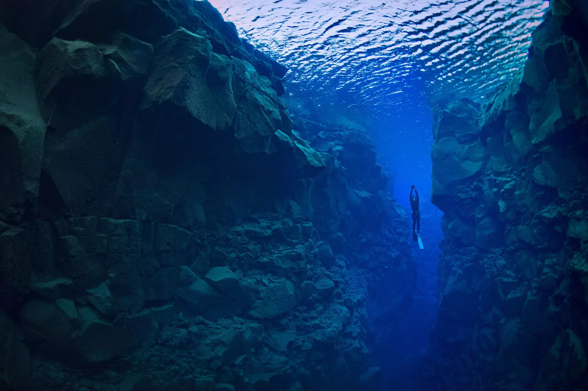 A free diver exploring the Silfra Fissure, which separates the North American and Eurasian continental plates. George Karbus Photography / Getty Images
