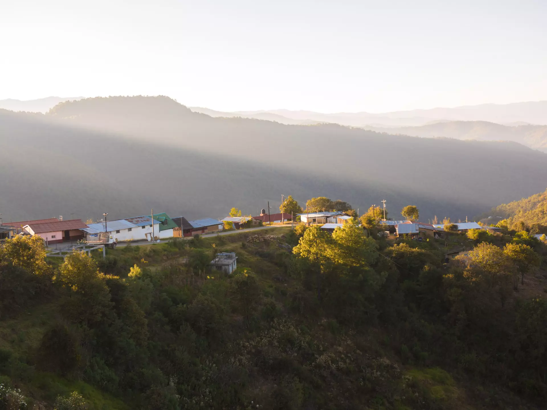 View of the sunrise over a rural mountain town in Oaxaca, Mexico.