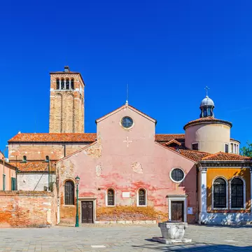 Chiesa di San Giacomo dall'Orio or San Giacomo Apostolo catholic church building with bell tower in Venice historical city centre, blue clear sky background in summer day, Veneto Region, Italy
