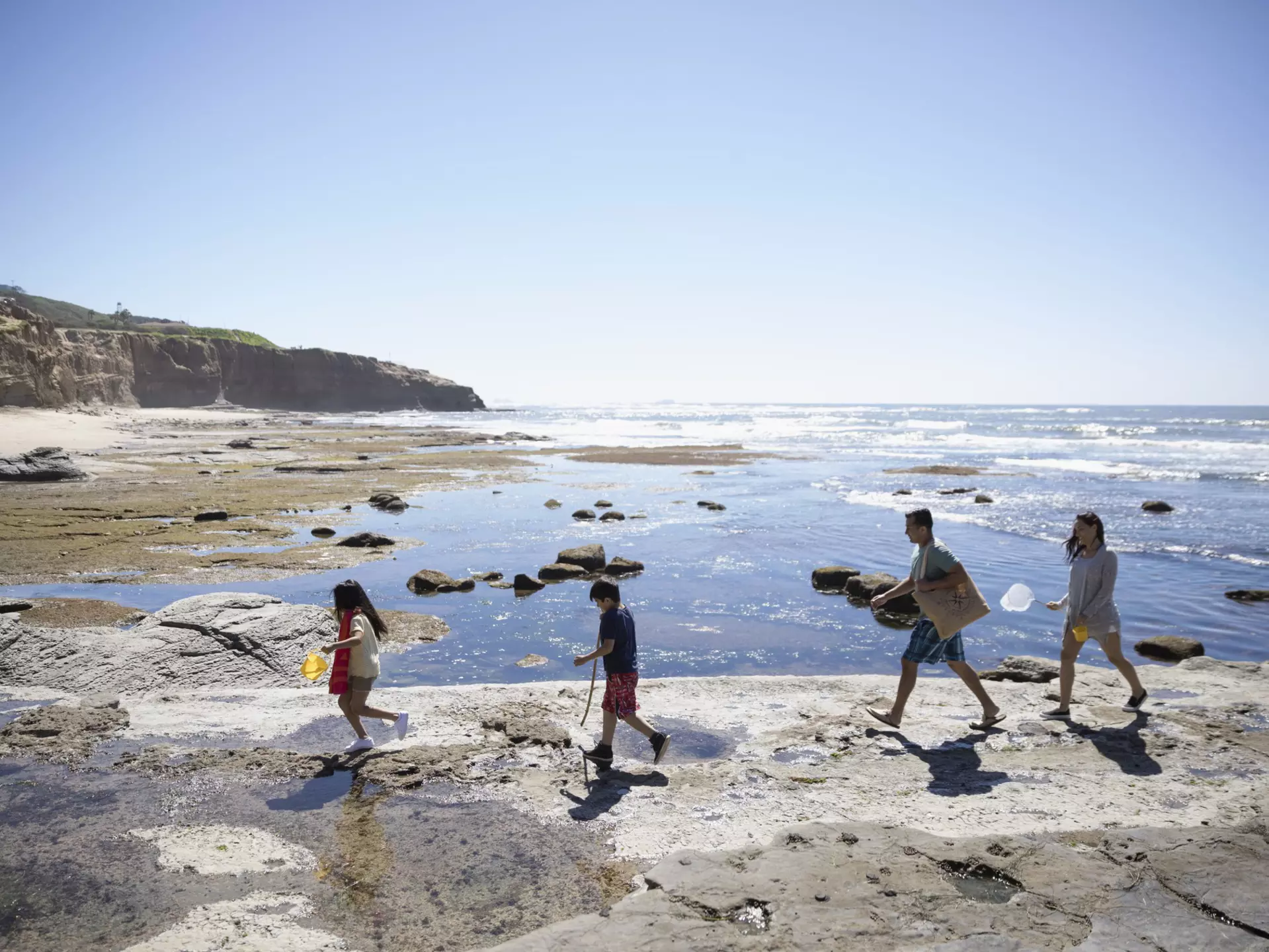 719872383
People Freedom Getting Away From It All On The Move Bonding Togetherness Lifestyles Nature Vacations Horizontal Full Length Outdoors 4-5 Years 8-9 Years 30-34 Years 35-39 Years High Angle View Side View Latin American and Hispanic Ethnicity Walking Following Holding Father Mother Daughter Son Brother Sister Family Family with Two Children USA Blue In A Row Sky Summer Rock - Object Day Sea Beach Pacific Ocean Childhood California San Diego Sunlight Healthy Lifestyle Child Adult Mid Adult 30-39 Years Color Image Beauty In Nature Weekend Activities Copy Space Four People Males Men Mid Adult Men Boys Females Women Mid Adult Women Girls Elementary Age Leisure Activity Photography Young Family Crag Travel Clear Sky Two Parents Husband Wife Sunny AutotagAuthentic - Do Not Delete
A family of four walking across the rocks on a sunny beach.