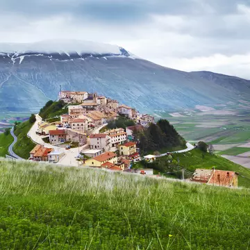 Monti Sibillini towering above hilltop village of Castelluccio.