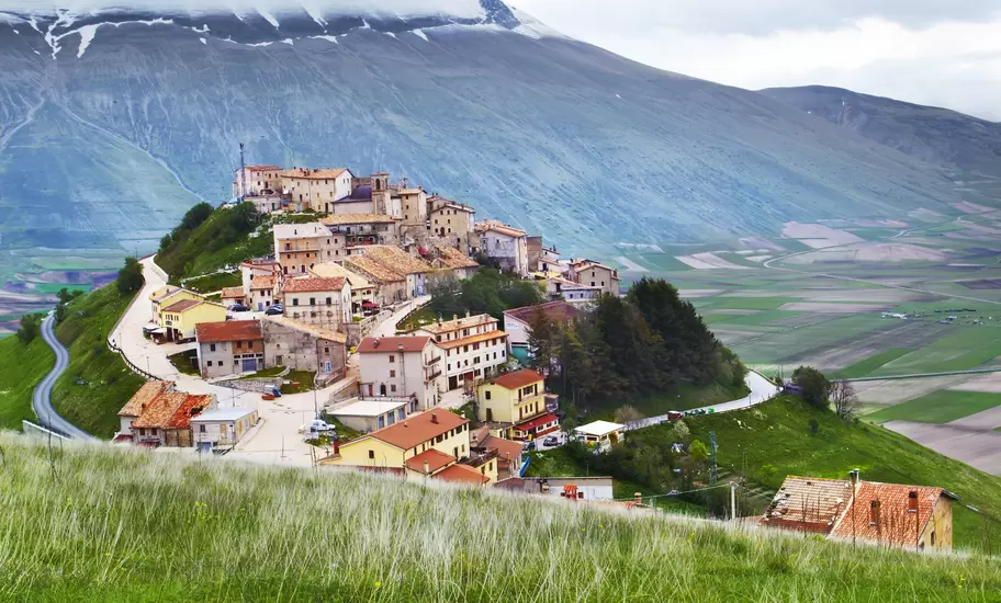 Monti Sibillini towering above hilltop village of Castelluccio.