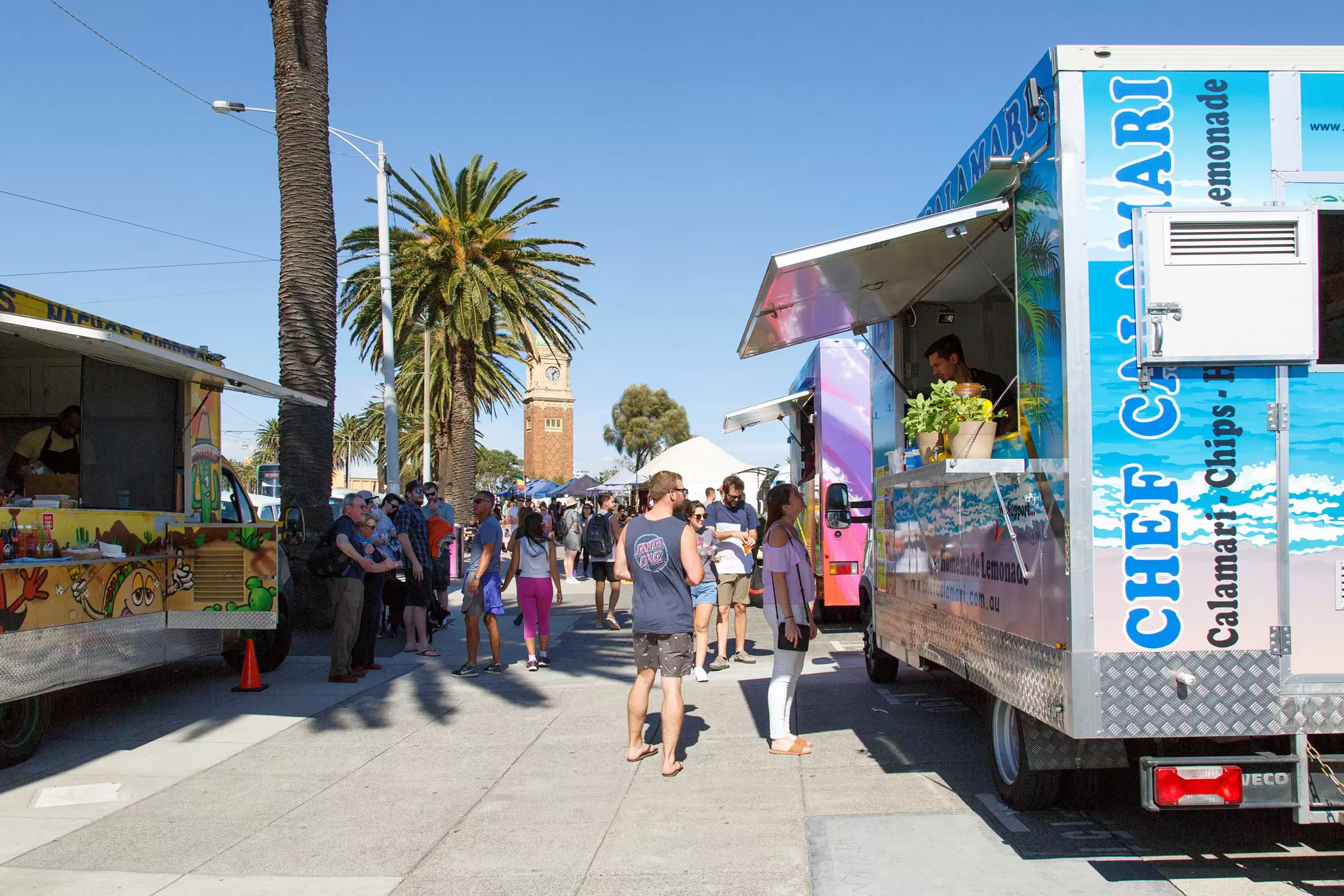 Sunday market stalls along the esplanade in St Kilda located on the foreshore of Port Phillip Bay. Temporary concession stands sell hot and cold take away foods.