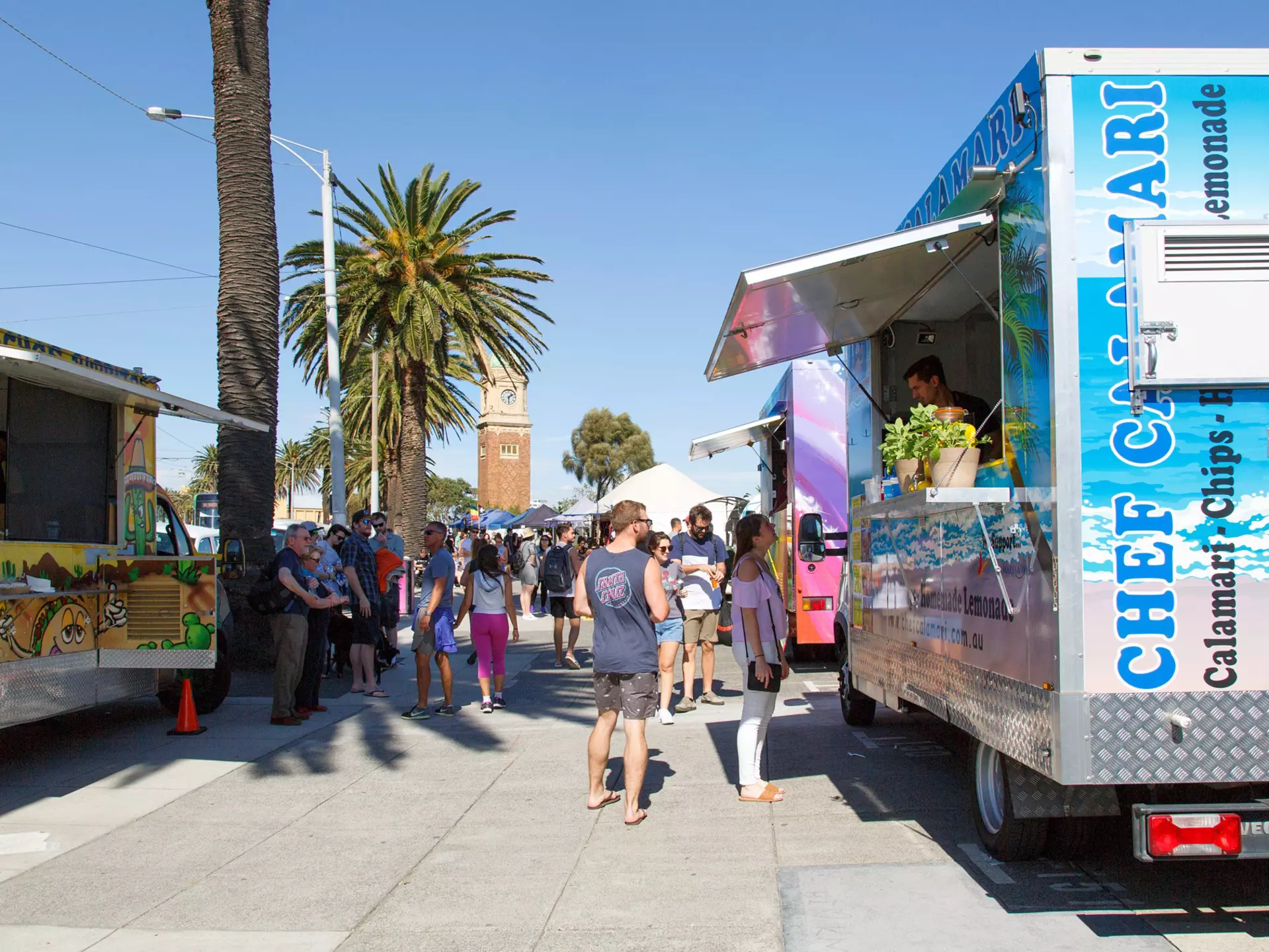 Sunday market stalls along the esplanade in St Kilda located on the foreshore of Port Phillip Bay. Temporary concession stands sell hot and cold take away foods.