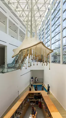 An art installation hangs from the ceiling of a modern museum building in Buenos Aires.