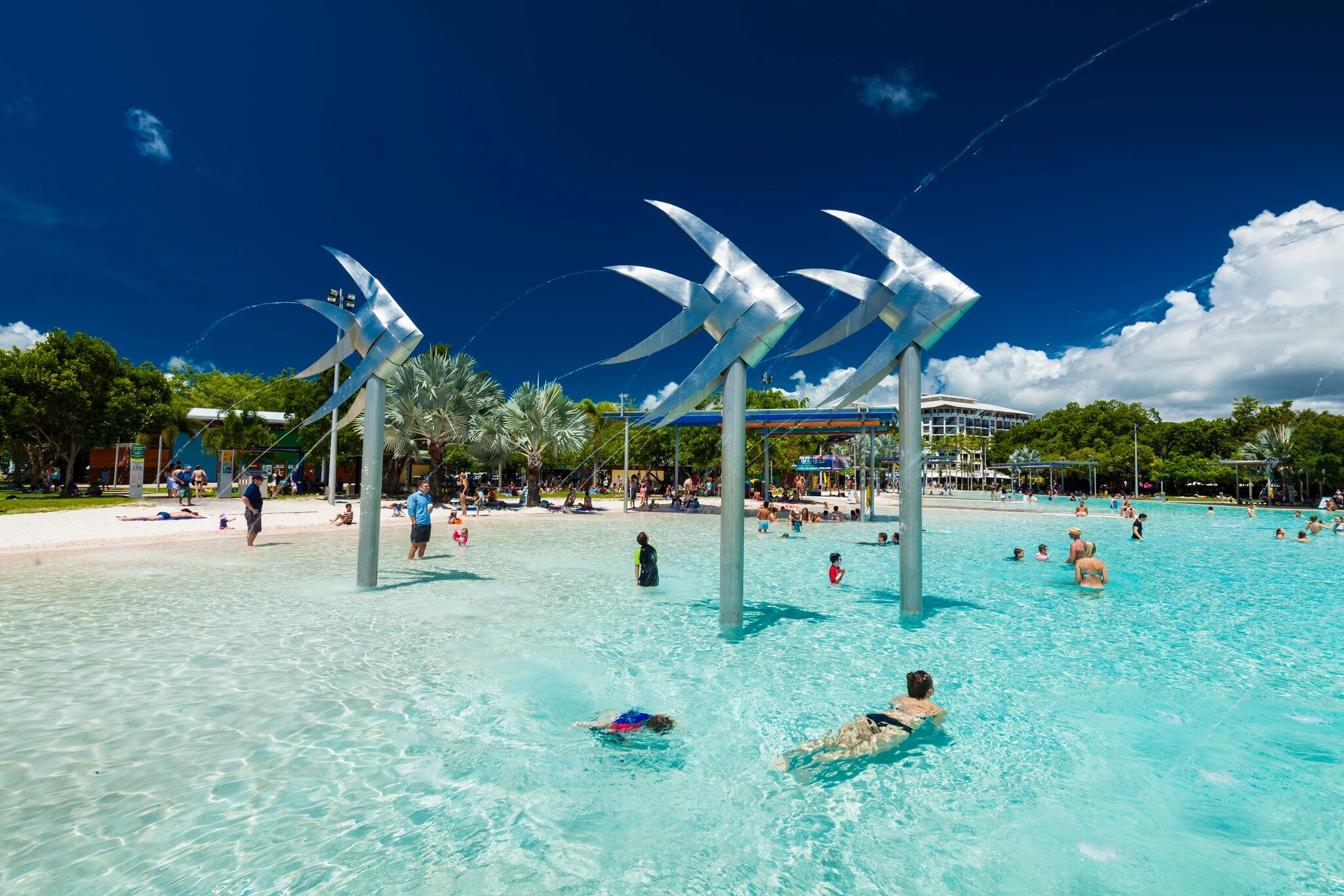 Tropical swimming lagoon on the Esplanade in Cairns with artificial beach, Queensland, Australia.