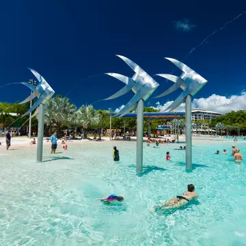 Tropical swimming lagoon on the Esplanade in Cairns with artificial beach, Queensland, Australia.