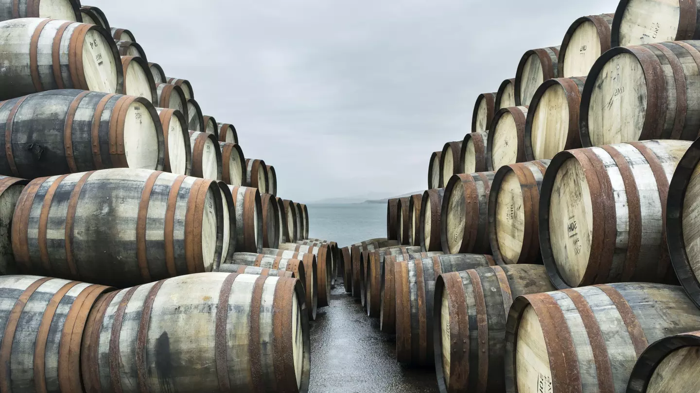 Two large stacks of whisky casks sit outside Bunnahabhain distillery, Isle of Islay, waiting to to be filled with whisky and stored