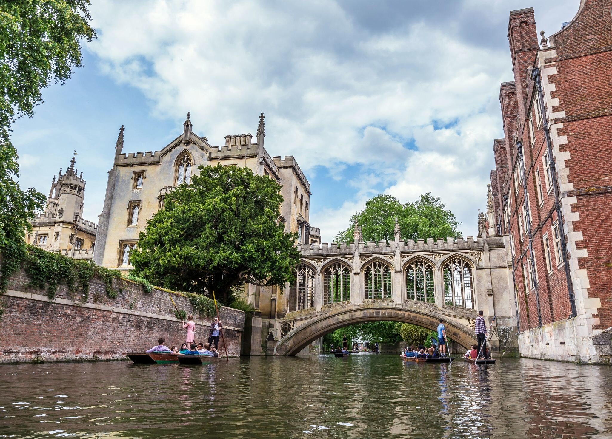 Tourists under Bridge of Sighs at Saint John's College. Named for a famous Venice landmark, this circa-1831 covered arch bridge connects campus buildings, Cambridge, England, 21st of May 2017; Shutterstock ID 763444831; your: Bridget Brown; gl: 65...