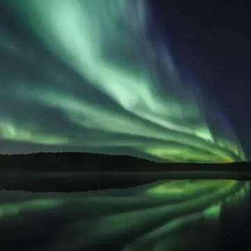 Aurora Borealis reflecting in lake, Yellowknife, Northwest Territories, Canada