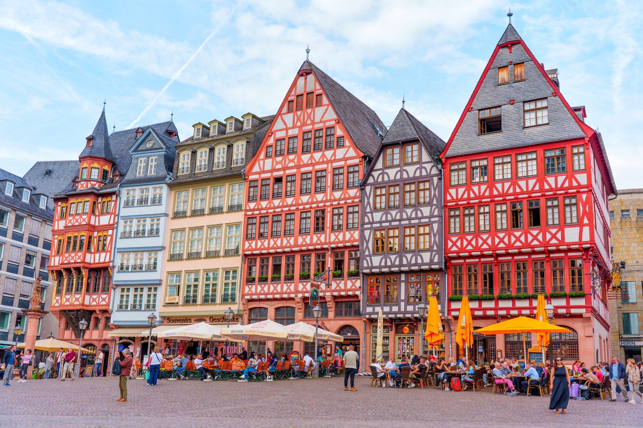 Frankfurt, Germany - June 10, 2025: Vibrant architecture of half-timbered houses in Römerberg Square, bustling with people enjoying outdoor cafes against a bright sky., License Type: media, Download Time: 2025-10-02T07:47:39.000Z, User: claramonitto, Editorial: true, purchase_order: 56530 - Guidebooks, job: Global Publishing-WIP, client: Germany 12, other: Clara Monitto