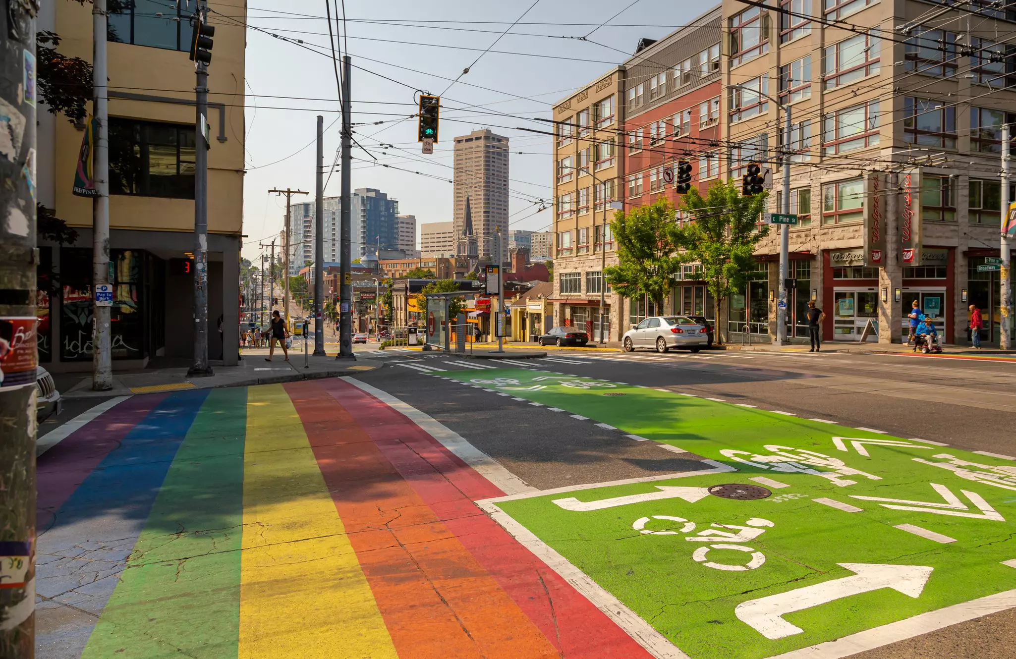 A colorful rainbow crosswalk and a green bike lane along Broadway and Pine Street in the Capitol Hill neighborhood