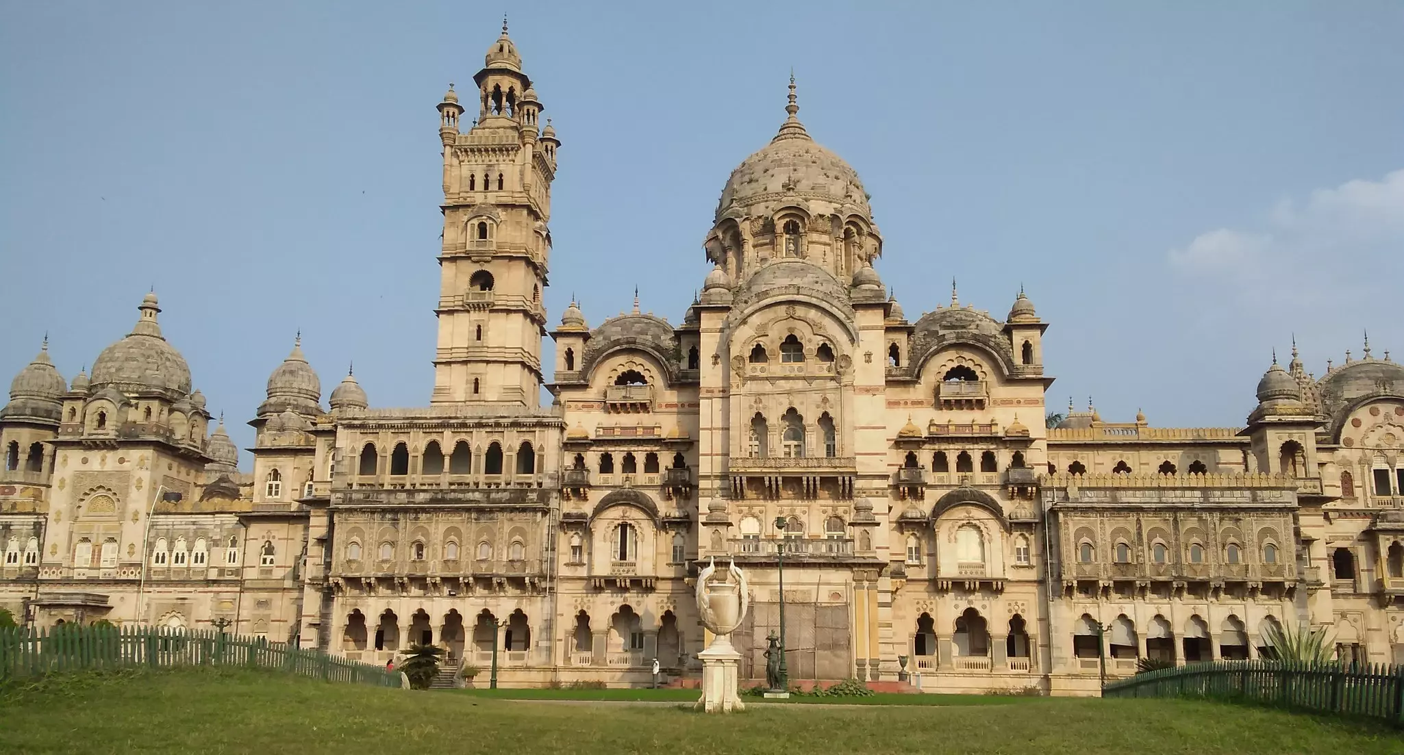 The facade of a huge palace, featuring towers, domes and windows in the Indo-Saracenic style.