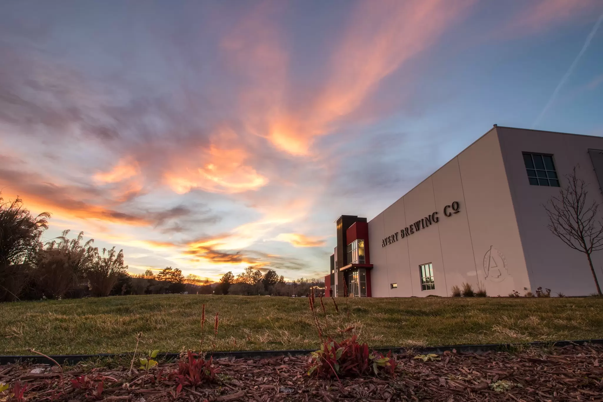The exterior of a large brewery building at sunset: Avery Brewing, Boulder.