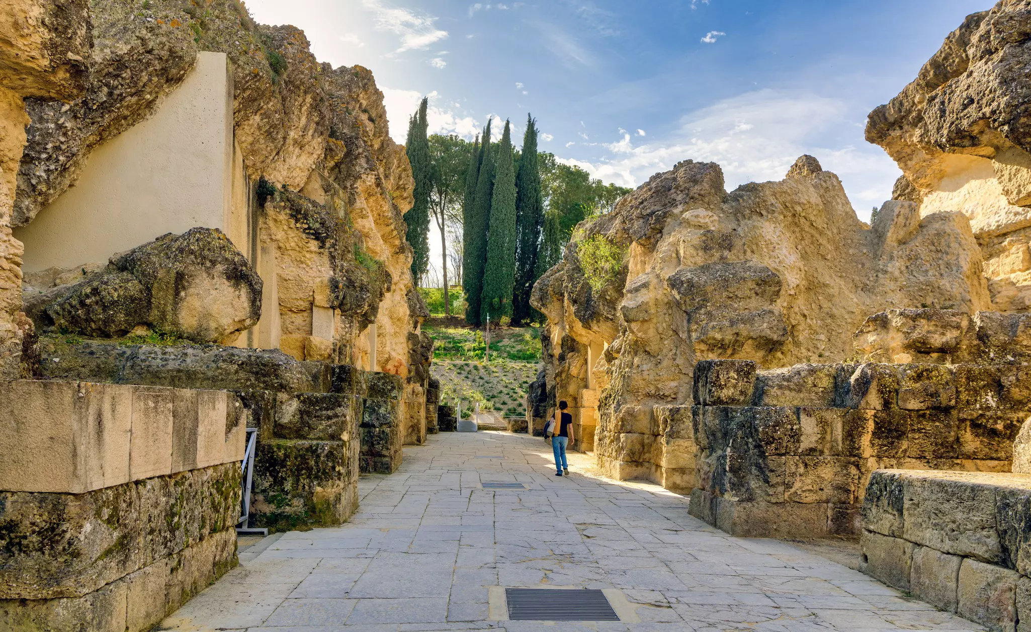 Santiponce, Spain. Circa March 2020. Woman walks among historic ruins in the Roman city of Italica in Santiponce, Spain.  License Type: media  Download Time: 2023-02-13T23:11:00.000Z  User:   Is Editorial: Yes  purchase_order:   