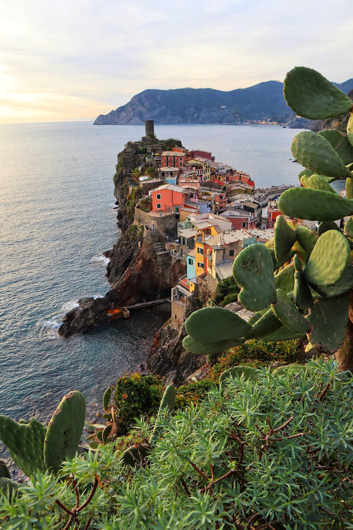 View of a Vernazza village with typical colorful multicolored houses and Castello Doria in the background in Cinque Terre, Italy.