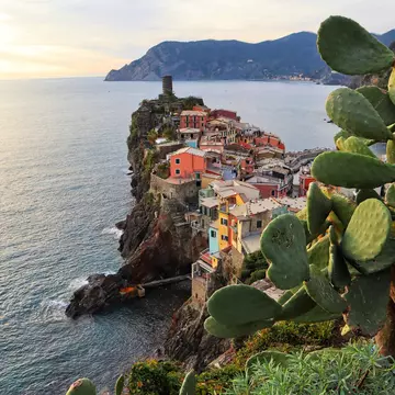 View of a Vernazza village with typical colorful multicolored houses and Castello Doria in the background in Cinque Terre, Italy.