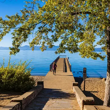 A tourist walks the pier at Kings Beach State Recreation Area, California.