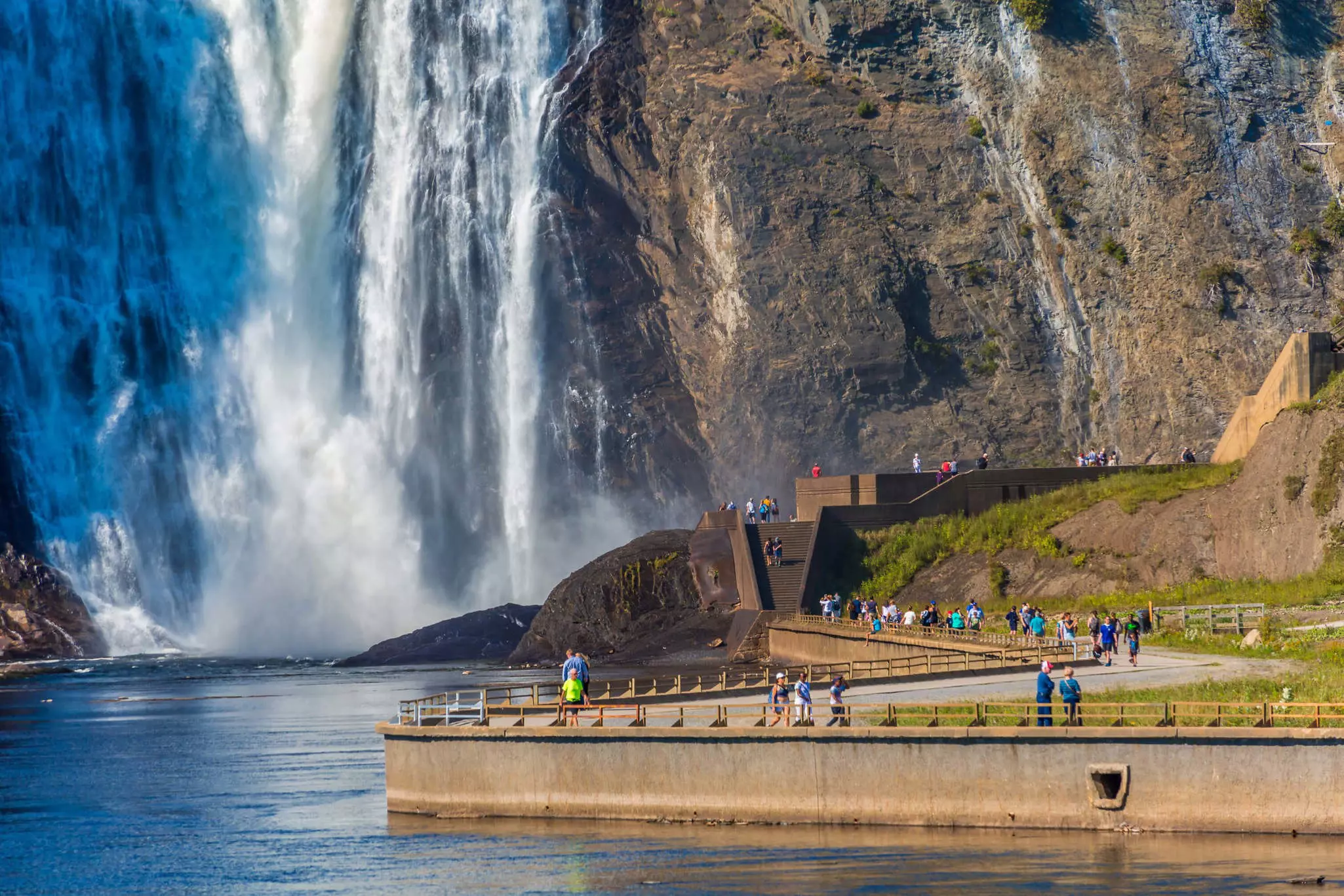 Tourists walking along the path toward Montmorency Falls