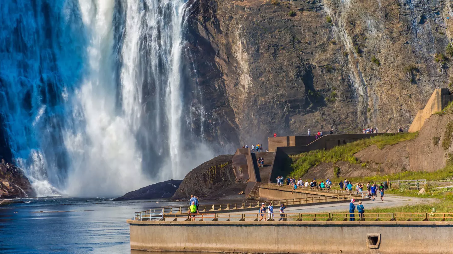 Tourists walking along the path toward Montmorency Falls