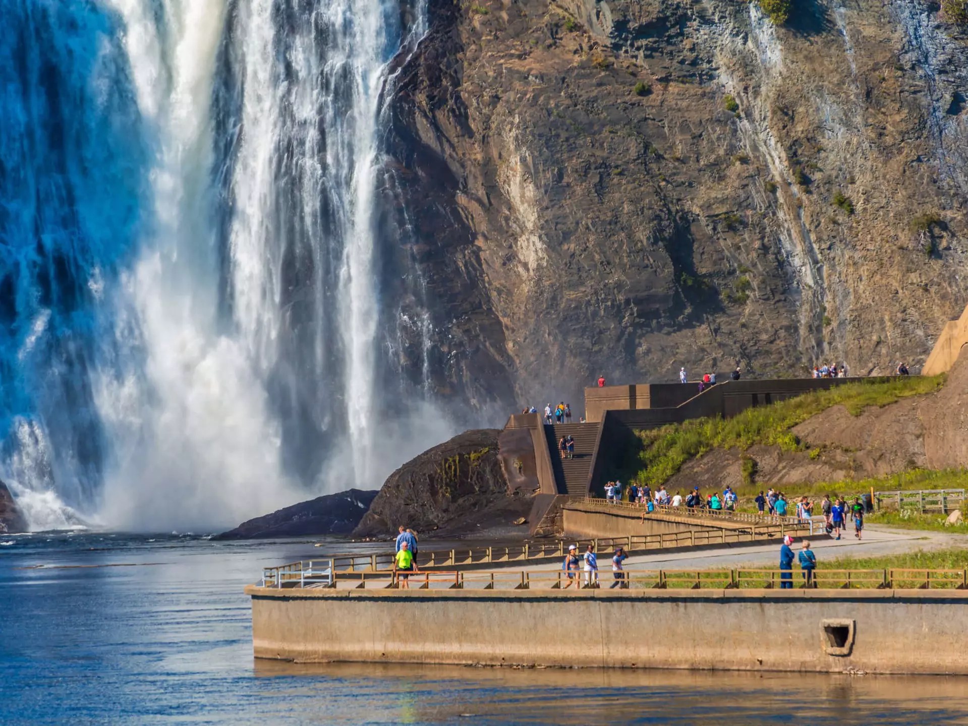 Tourists walking along the path toward Montmorency Falls