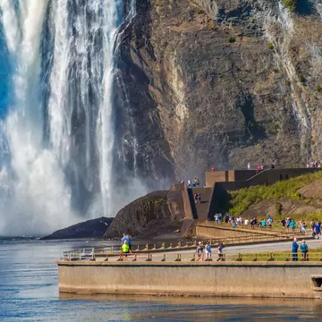 Tourists walking along the path toward Montmorency Falls