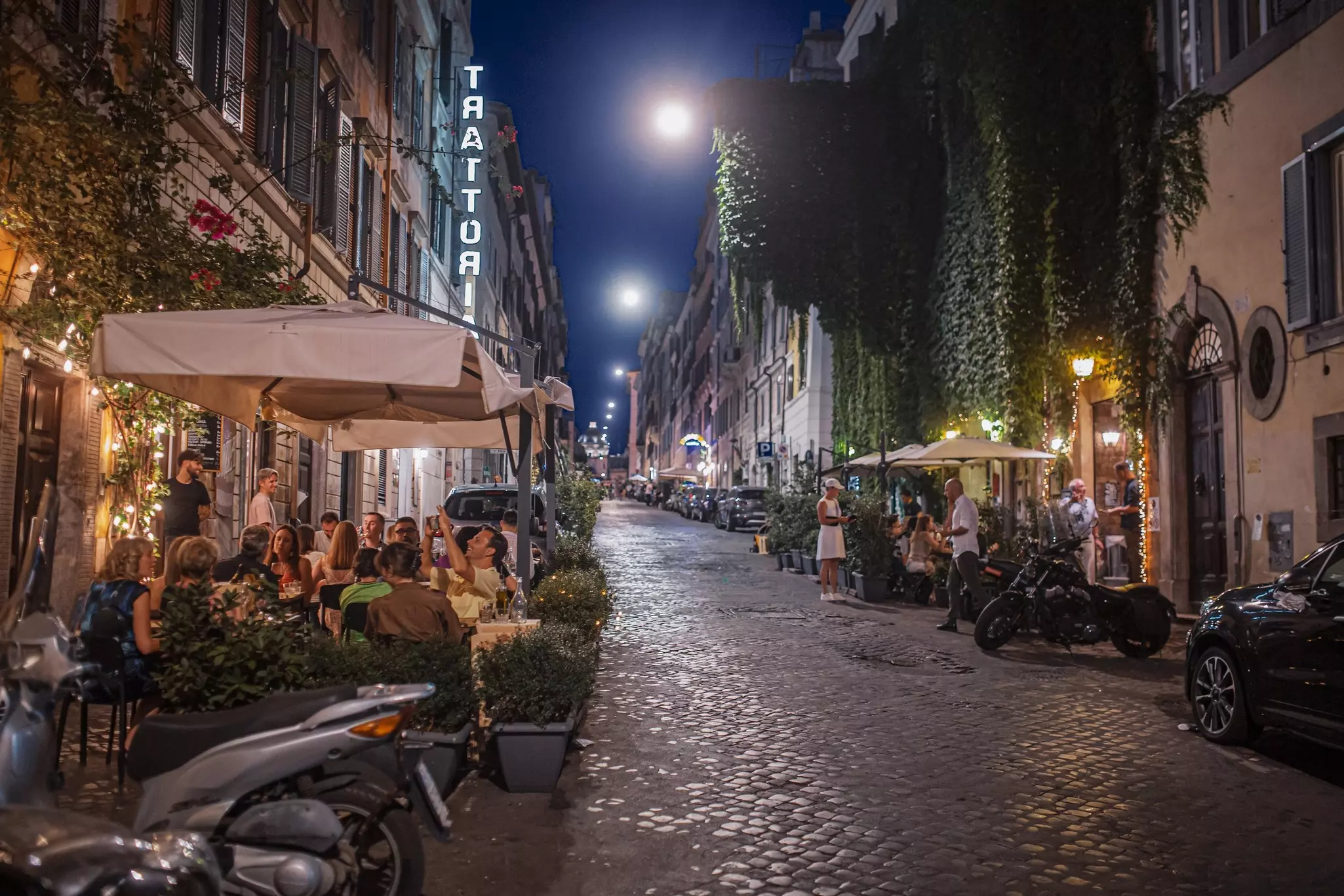 Unidentified people at bars and restaurants on the streets of Rome, Italy.