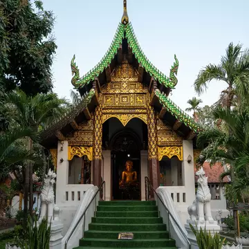Chiang Mai, Thailand. The entrance pavilion of Wat Umong Mahathera Chan is seen with a Buddha statue inside.
