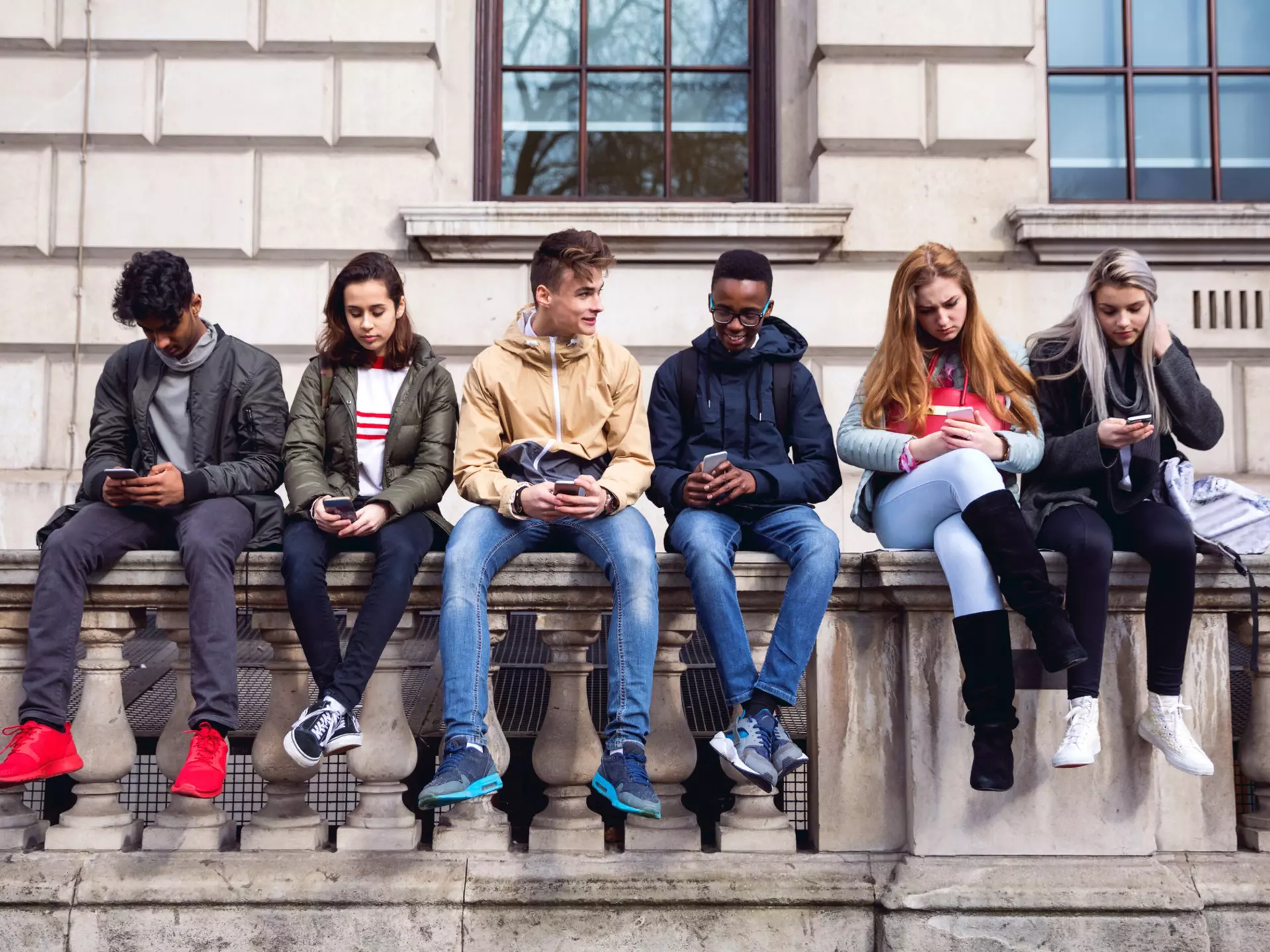 Teenagers students using smartphone on a school break