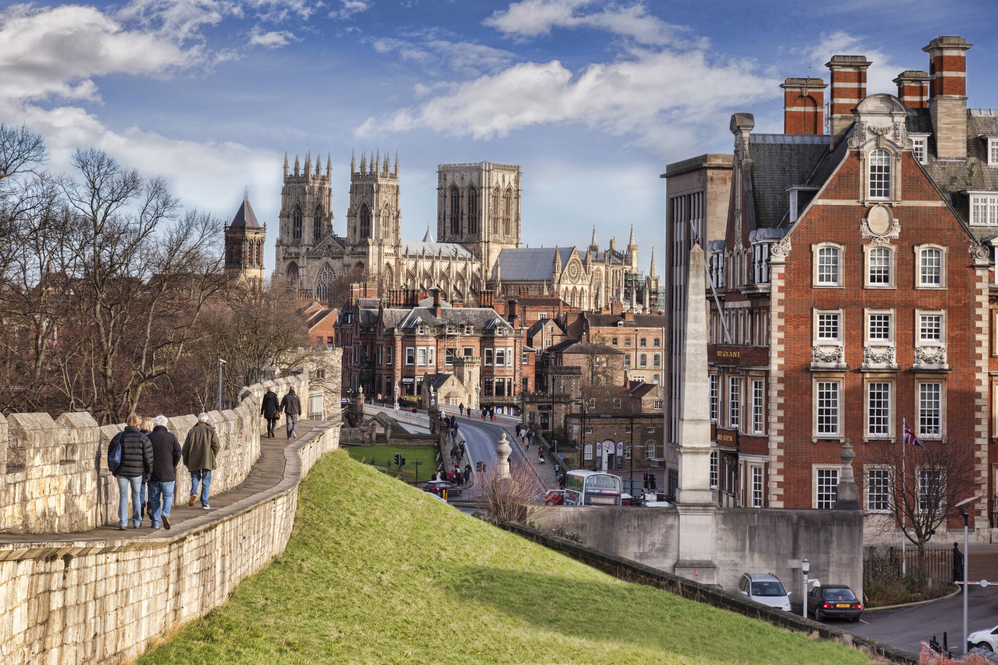26 January 2015: York, North Yorkshire, England -  a view along the city wall towards York Minster, with tourists walking along the wall.
1127694894
city, people, tourism, yorkshire - england, north yorkshire, england, english culture, minster, cathedral, winter, architecture, history, travel destinations, building exterior, famous place, sky, stone material, travel, fortified wall, gothic style, british culture, british, english, view, medieval, york - yorkshire, surrounding wall, tourist, incidental people