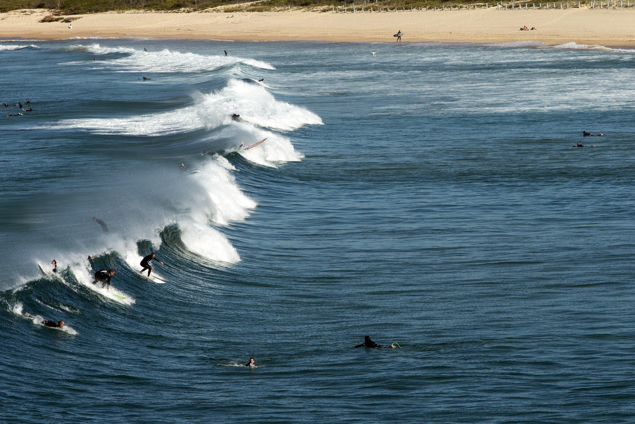 Surfers at Maroubra Beach catching a winter swell in Sydney, Australia.