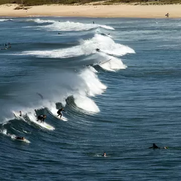 Surfers at Maroubra Beach catching a winter swell in Sydney, Australia.